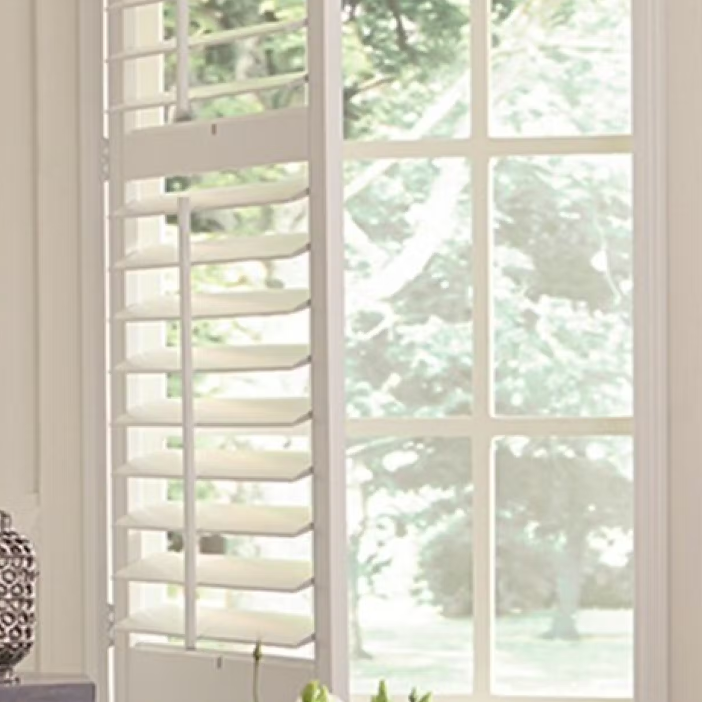  An assortment of window treatments including classic wooden shutters, sleek modern blinds and shades.